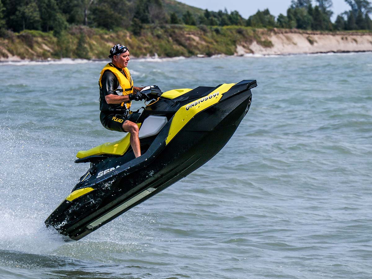 A person about to land in the water on a jet ski